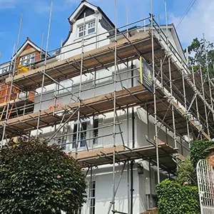 A house under construction with scaffolding around it.